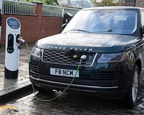 Black car with electrical cable entering it at the front