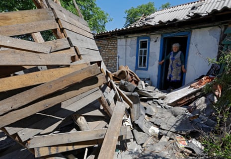 Local resident Lilia Tabala, 75, looks at the ruins of her garage and summer kitchen, destroyed by recent shelling in the town of Horlivka in the Donetsk region, in Russian-occupied Ukraine.