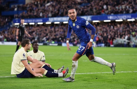 Malo Gusto runs away after scoring Chelsea's second with two Everton defenders on the floor