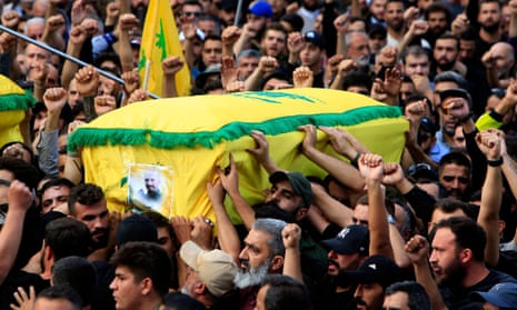 People carry a casket of a Hezbollah member killed in Israeli strikes during a funeral in the town of Khirbet Selm, southern Lebanon, on 10 October 2023.
