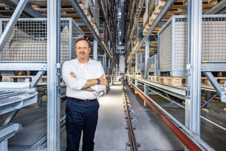 Bernard Krone standing in a factory with arms folded