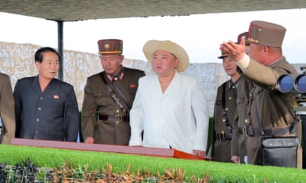 Kim Jong-un overseeing a military striking drill of long-range artillery units.