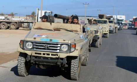 Military vehicles of the Libyan government forces head out to the front line from Misrata