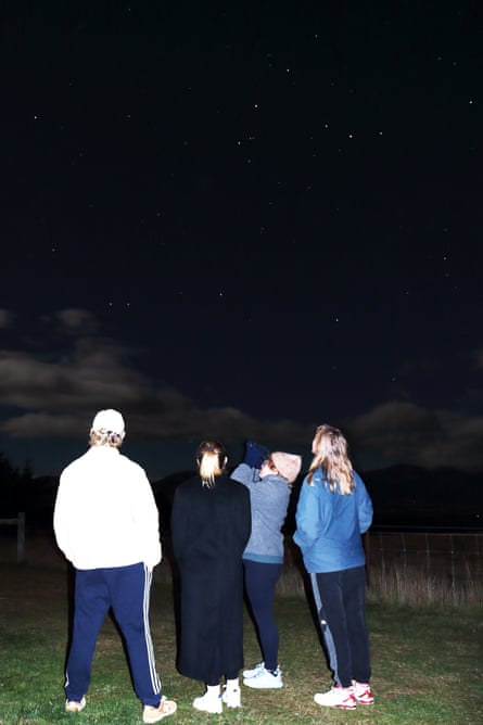 Four people gazing at the night sky