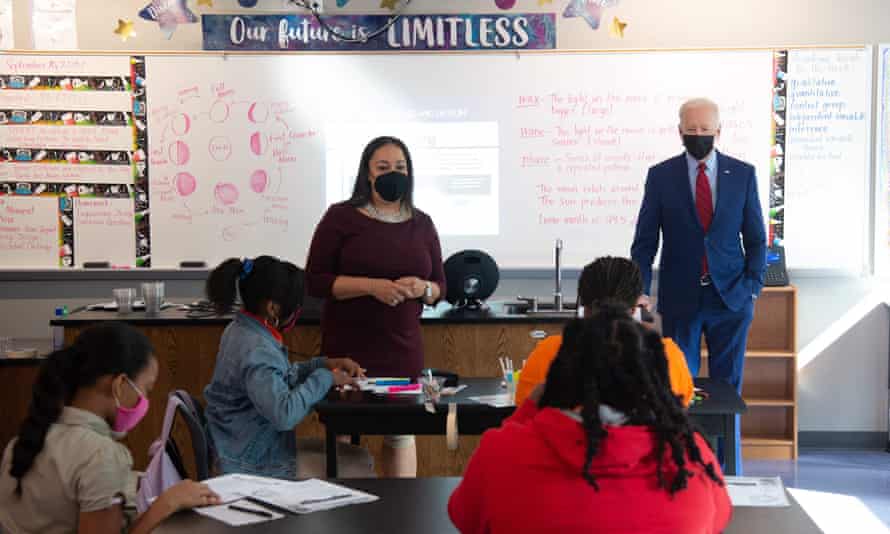 Joe Biden, alongside teacher Michelle Taylor, speaks to students in a 6th grade science class, at Brookland middle school in Washington DC last month.