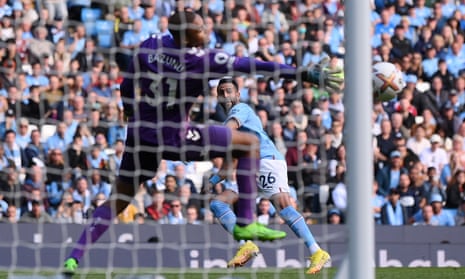 Riyad Mahrez hits the ball past Southampton goalkeeper Gavin Pazono to give Manchester City the third goal.