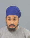 he wears a blue turban and has a wispy dark beard and moustache.