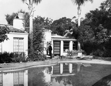 black and white photo of a person in front of a house