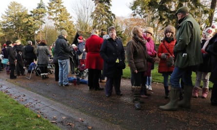 Onlookers wait in vain for the Queen’s arrival at the church near the Sandringham estate.