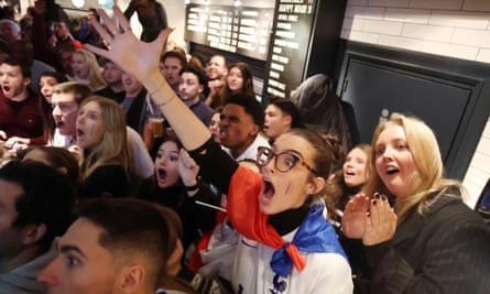 Fans react as they watch the final in a bar in Paris