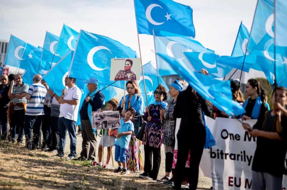 Demonstrators holding Uighur flags in Berlin before a meeting between German chancellor Angela Merkel and Chinese premier Li Keqiang.
