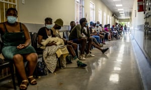 People queue to be vaccinated against Covid-19 at the Lenasia South Hospital, near Johannesburg on 1 December as the Omicron variant spreads across the country.