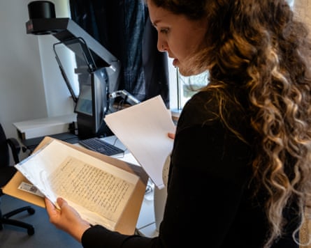 Carla Seibert stands reading a letter