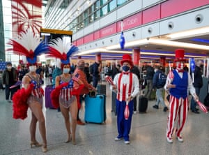 Performers entertain passengers at London Heathrow Airport’s T3 as the US reopens its borders to UK visitors in a significant boost to the travel sector.