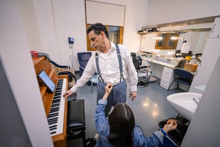 Juan Diego Florez warms up inside his dressing room at the Royal Opera House whilst also having alterations done on his costume, prior to performance as Hoffman in The Tales of Hoffman.
