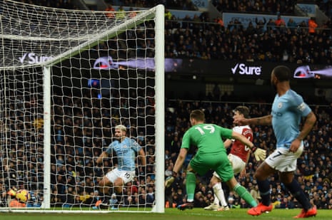 Manchester City’s English midfielder Raheem Sterling (R) watches as Sergio Aguero taps home his cross