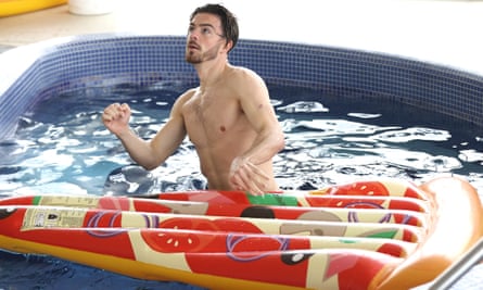 Jack Grealish of England plays with an inflatable pizza slice in the swimming pool at St George’s Park.
