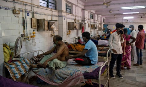 Patients sit on hospital beds inside the emergency ward in India’s eastern Bihar state, where 90% of people live in villages.