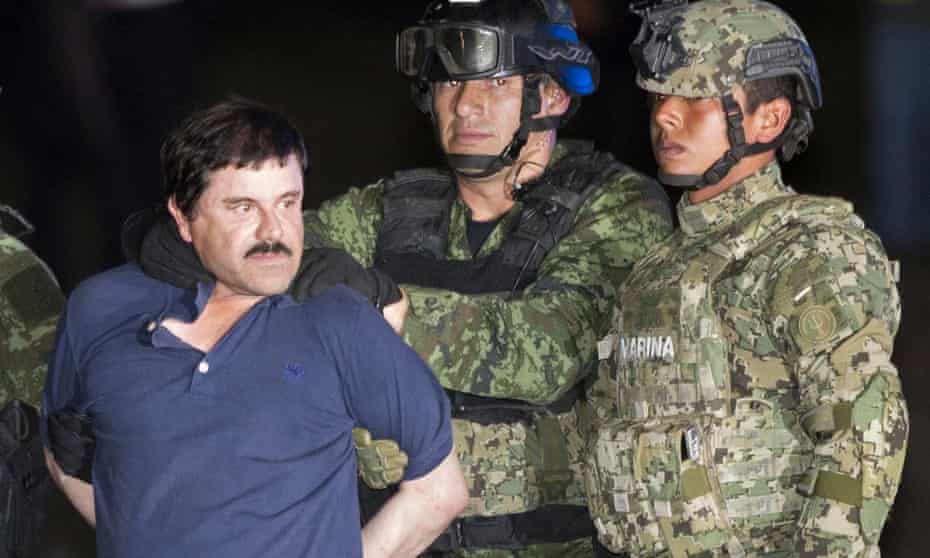 Joaquin ‘El Chapo’ Guzman is escorted to a helicopter in handcuffs in Mexico City on 8 January after his most recent capture.