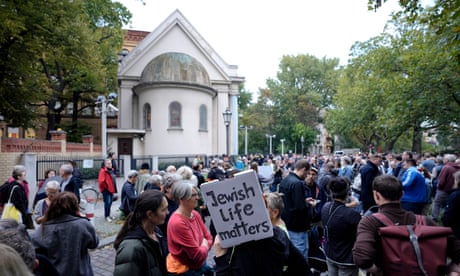 Hundreds of Berliners gather outside of the Fraenkelufer synagogue, with one woman carrying a banner that reads 'Jewish life matters'