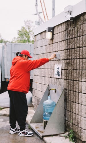 Ken Greene gathers water for his home.