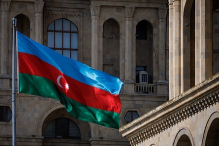 The national flag of Azerbaijan flies in Baku.