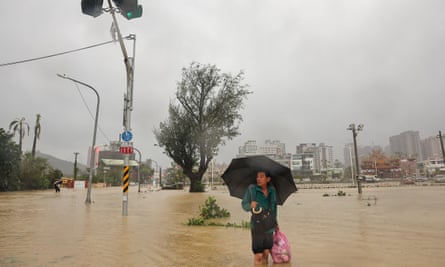 A man wades through flood water