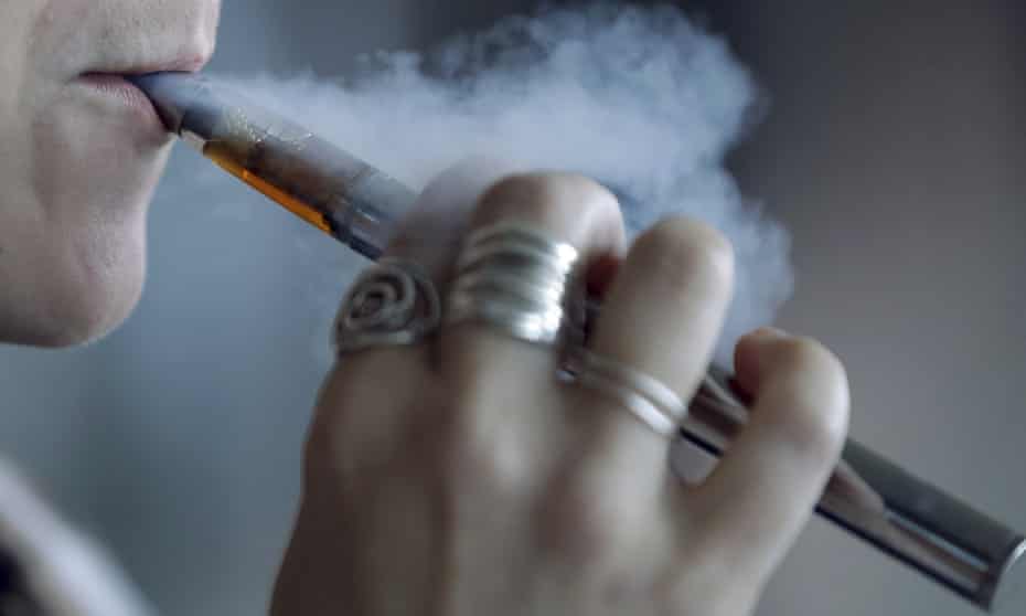 a woman using a vaping device