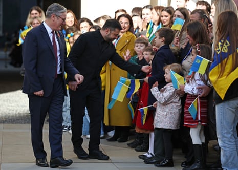 Britain's prime minister Keir Starmer, left, and Ukraine's President Volodymyr Zelenskyy are greeted by Ukrainian schoolchildren as they arrive at the Foreign, Commonwealth and Development Office (FCDO), for a meeting of the Coalition of the Willing, in London, Friday Oct. 24, 2025.