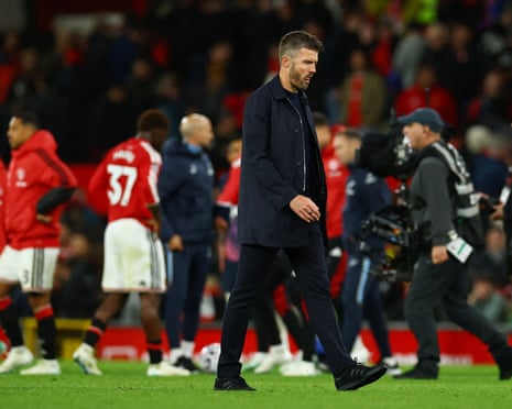 Manchester United manager Michael Carrick walks across the pitch looking deflated