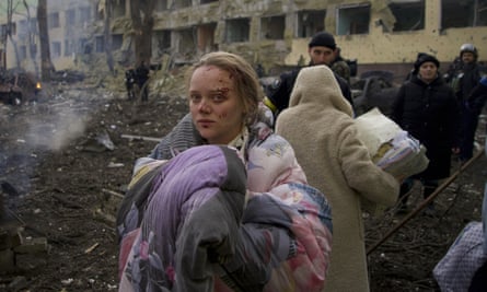 A woman standing outside a maternity hospital in Mariupol after it was shelled by Russia.