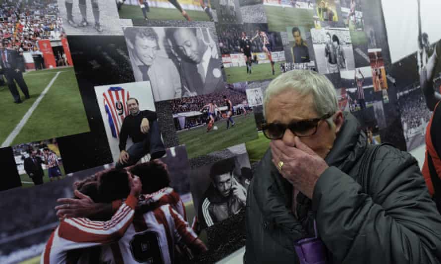 A woman cries next to tributes to Quini outside Sporting Gijón’s El Molinón Stadium in Gijón, where Quini died on Tuesday.