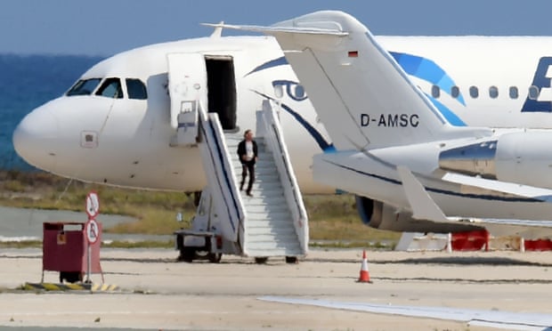 A man believed to be the hijacker of EgyptAir flight MS181 leaves the plane before surrendering to security forces after a six-hour standoff at Larnaca airport in Cyprus on Tuesday.