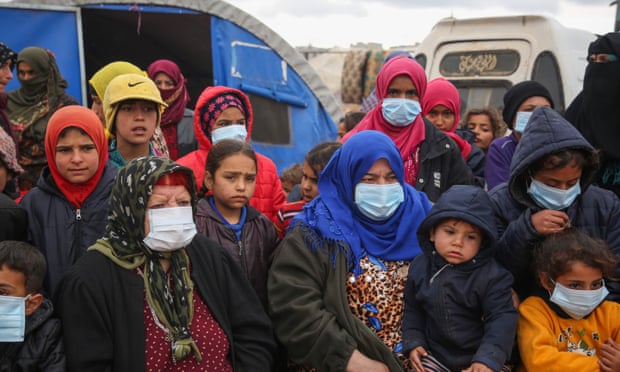 Displaced Syrians, some wearing protective masks, pictured earlier this year in the northwestern province of Idlib.