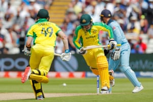 Smith and Carey run between the wickets while Australia reaches 100.