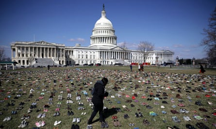 Shoes representing children killed by gun violence are spread out on the lawn on the east side of the US Capitol in 2018.