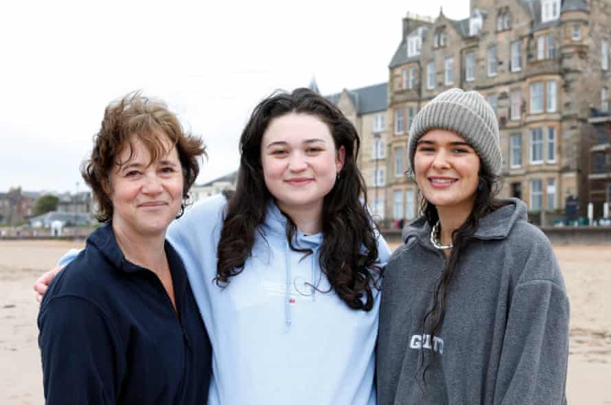Rowena Maisie and Poppy on the sand with buildings in the background