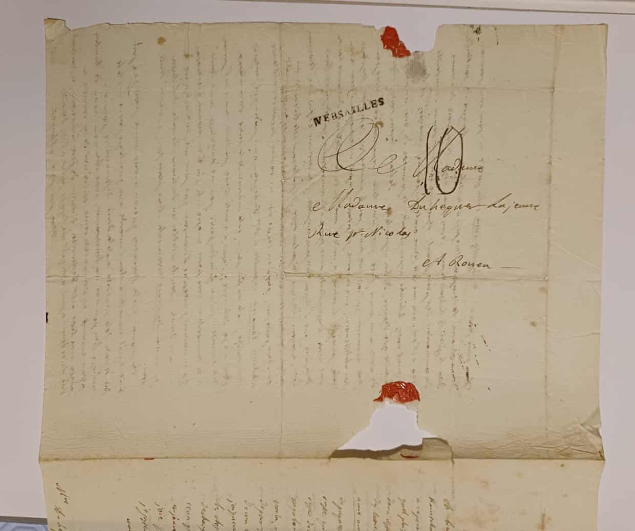 An old handwritten letter from Jean-André Mongez, with faded ink, a red wax seal and torn edges