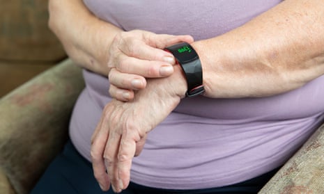 An elderly woman wearing a Fitbit