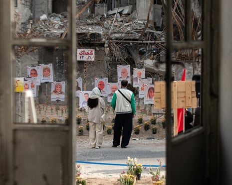 Iranians looks at the ruins of homes destroyed in US-Israeli airstrikes in Tehran