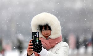 A woman takes a selfie in the snow