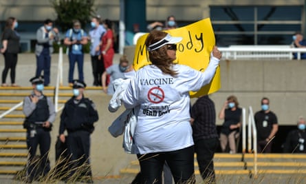 A woman protests mandatory Covid-19 vaccines outside the Royal Alexandra hospital in Edmonton.