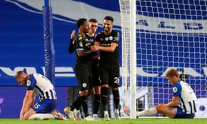 Manchester City’s Raheem Sterling (2-L) celebrates amid Brighton’s frazzled defenders.