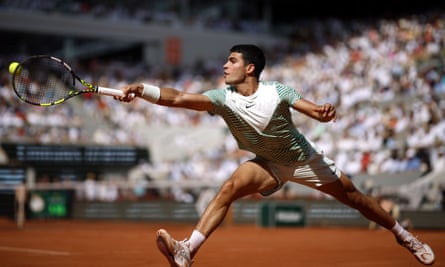 Carlos Alcaraz hits a return to Novak Djokovic in their semi-final at the 2023 French Open