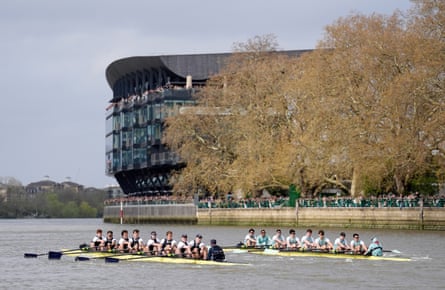 The crews in the men’s race pass Fulham’s Craven Cottage.