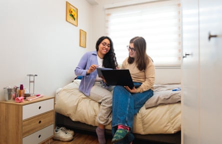 Two classmates socialising in a bedroom