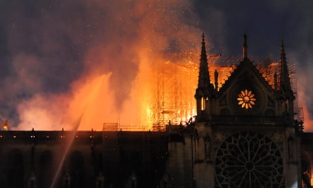 Firefighters tackle the blaze as the roof of Notre Dame burns
