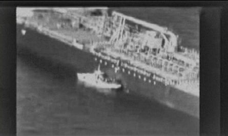 Videograb released by US Central Command purports to show an Iranian navy patrol boat in the Gulf of Oman approaching a Japanese tanker and removing an unexploded mine.
