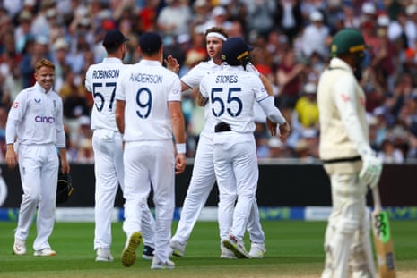 Stuart Broad celebrates with teammates after taking the wicket of Australia's Scott Boland.