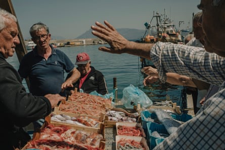 Men talking on a harbour quay.
